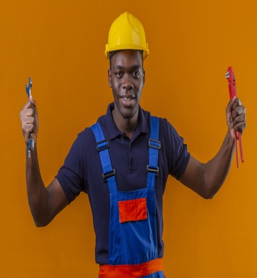 young-african-american-builder-man-wearing-construction-uniform-safety-helmet-holding-adjustable-wrenches-raised-hands-with-happy-face-standing-orange (1) (1)